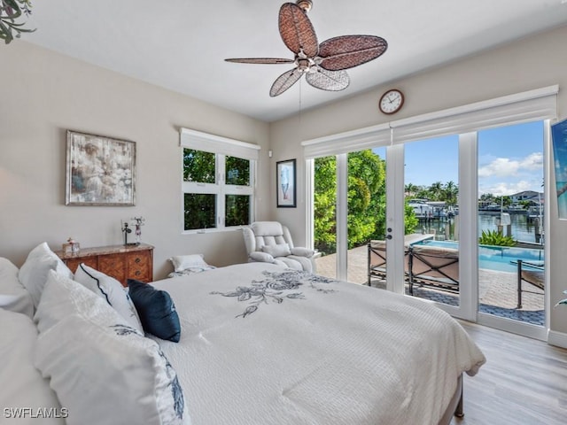 622 Bimini Ave, Marco Island, FL 34145 - bedroom with access to exterior, light wood-style floors, ceiling fan, a water view, and baseboards