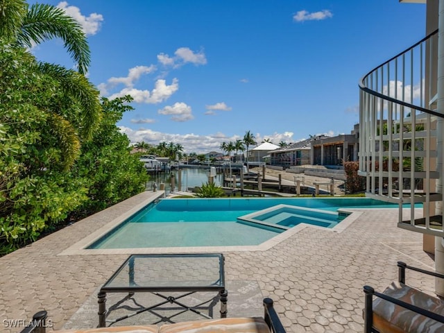 622 Bimini Ave, Marco Island, FL 34145 - view of pool with boat lift, a boat dock, a patio area, a water view, and a pool with connected hot tub