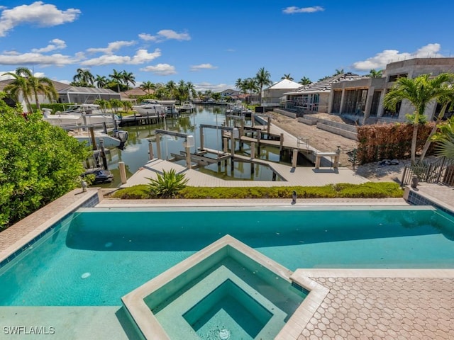 622 Bimini Ave, Marco Island, FL 34145 - view of swimming pool featuring a pool with connected hot tub, a water view, a dock, and boat lift