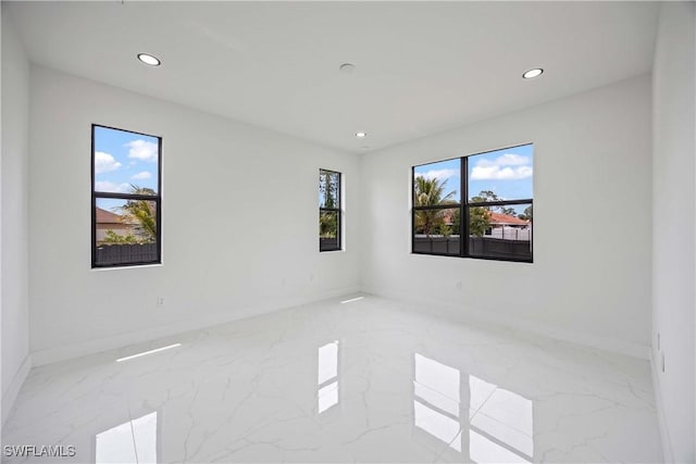 3300 18th St W, Lehigh Acres, FL 33971 - empty room with marble tiled flooring, recessed lighting, and baseboards