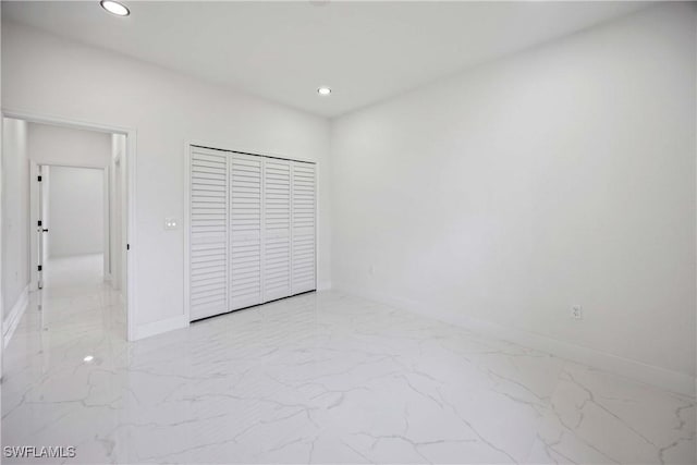 3300 18th St W, Lehigh Acres, FL 33971 - unfurnished bedroom with light marble finish floors, baseboards, recessed lighting, and a closet