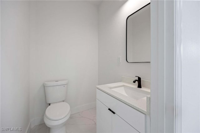 3300 18th St W, Lehigh Acres, FL 33971 - bathroom featuring marble look tiles, baseboards, vanity, and toilet