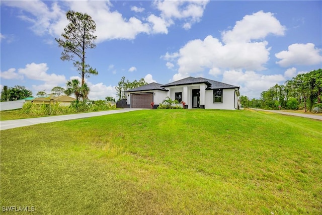 3300 18th St W, Lehigh Acres, FL 33971 - prairie-style house featuring concrete driveway, a garage, a front lawn, and stucco siding