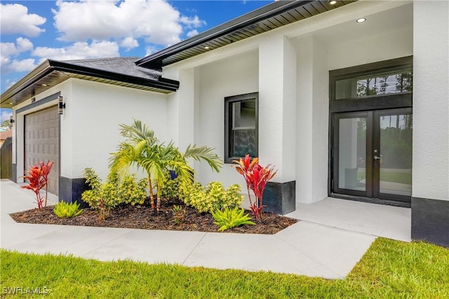 3300 18th St W, Lehigh Acres, FL 33971 - doorway to property with french doors, a garage, and stucco siding