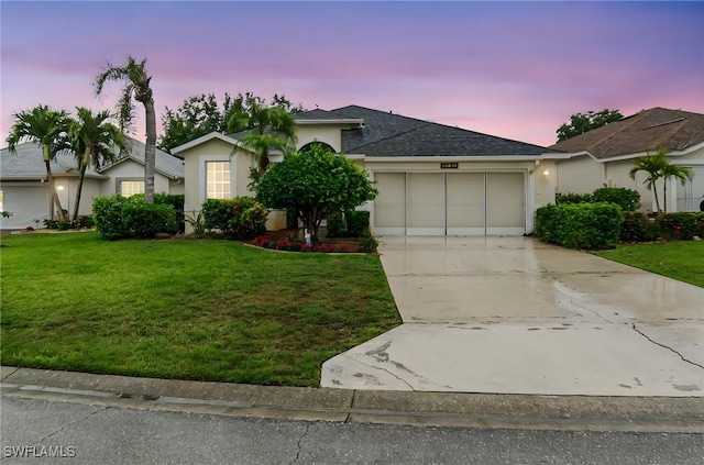 9750 Sassafras Ct, Estero, FL 33928 - single story home with an attached garage, concrete driveway, a front lawn, stucco siding, and roof with shingles