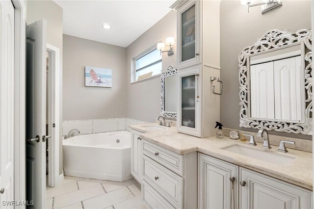 9750 Sassafras Ct, Estero, FL 33928 - bathroom with double vanity, a garden tub, and tile patterned flooring