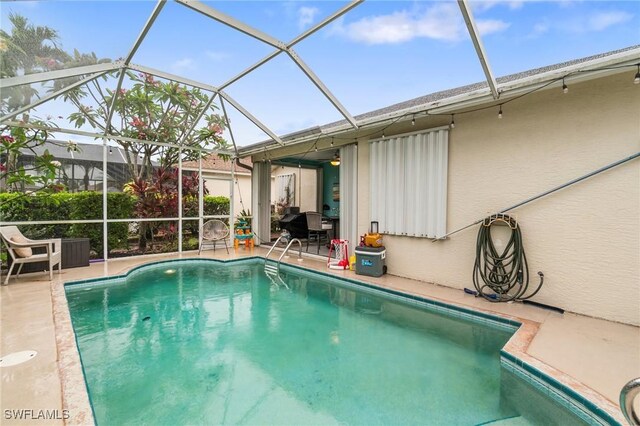 9750 Sassafras Ct, Estero, FL 33928 - swimming pool with a patio and glass enclosure