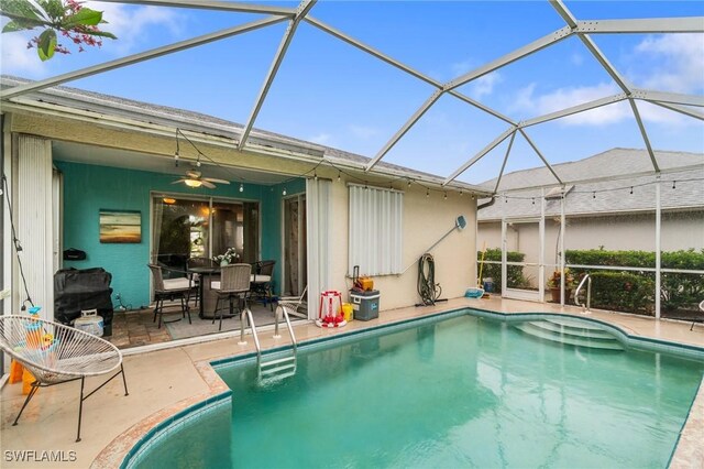 9750 Sassafras Ct, Estero, FL 33928 - swimming pool with a ceiling fan, a patio area, glass enclosure, and outdoor dining space