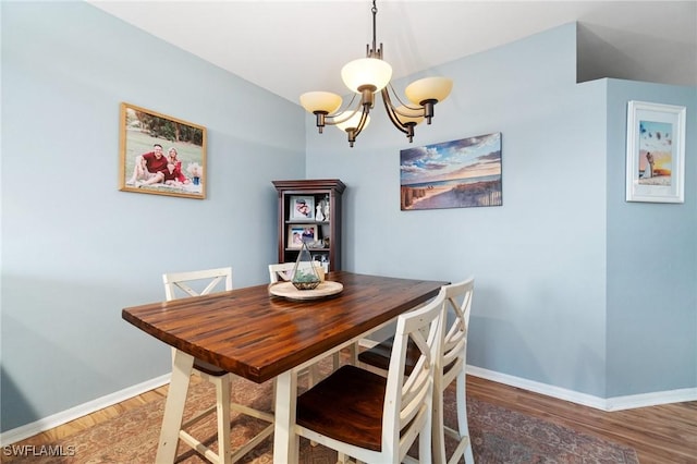 9750 Sassafras Ct, Estero, FL 33928 - dining space with a chandelier, baseboards, and wood finished floors