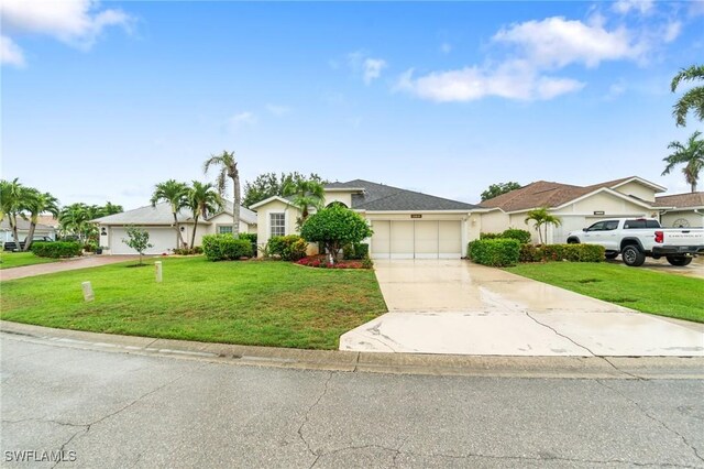 9750 Sassafras Ct, Estero, FL 33928 - ranch-style house with concrete driveway, a front yard, a garage, and stucco siding