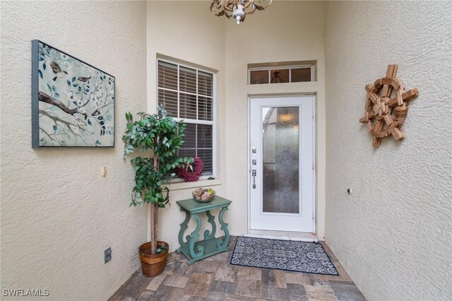 9750 Sassafras Ct, Estero, FL 33928 - view of exterior entry featuring stucco siding