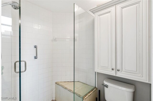 9750 Sassafras Ct, Estero, FL 33928 - bathroom featuring a tile shower and toilet