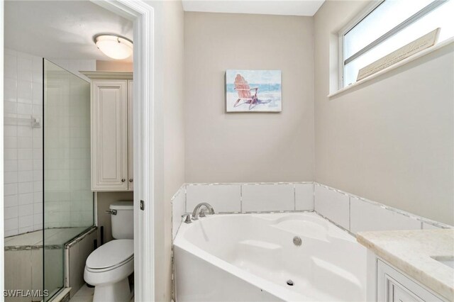 9750 Sassafras Ct, Estero, FL 33928 - bathroom with a bath, toilet, vanity, and a shower stall
