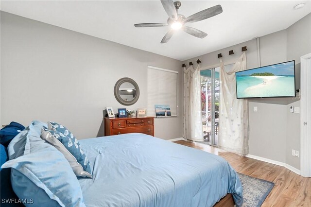 9750 Sassafras Ct, Estero, FL 33928 - bedroom with access to outside, wood finished floors, baseboards, and ceiling fan