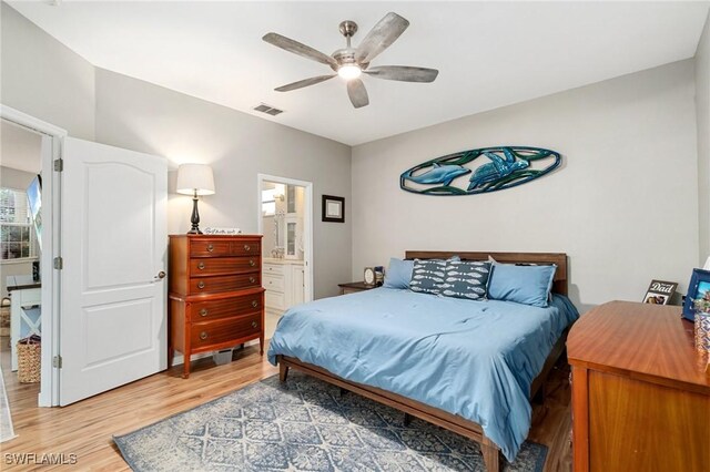 9750 Sassafras Ct, Estero, FL 33928 - bedroom with light wood-style floors, ceiling fan, and ensuite bath
