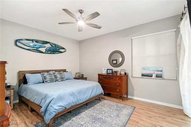 9750 Sassafras Ct, Estero, FL 33928 - bedroom with wood finished floors, baseboards, and ceiling fan