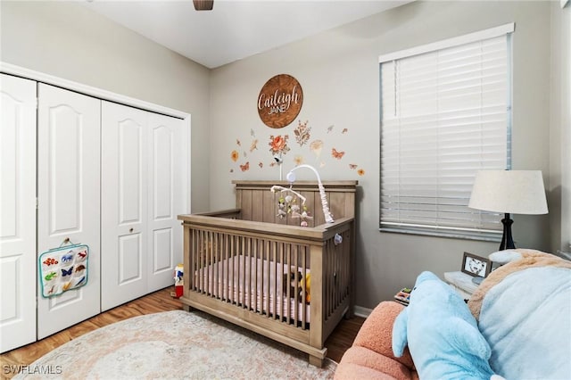 9750 Sassafras Ct, Estero, FL 33928 - bedroom with a closet, ceiling fan, wood finished floors, and a nursery area