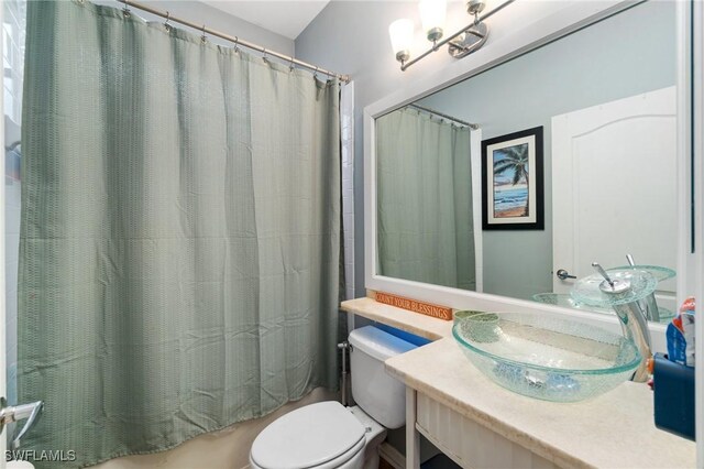 9750 Sassafras Ct, Estero, FL 33928 - bathroom featuring toilet, vanity, and shower / bath combination with curtain