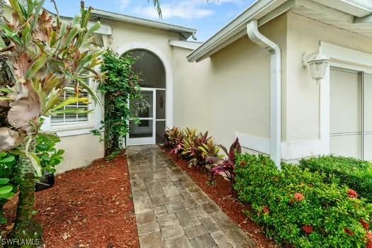 9750 Sassafras Ct, Estero, FL 33928 - view of exterior entry with stucco siding