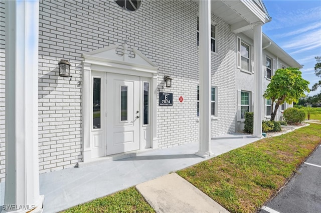 property entrance with brick siding
