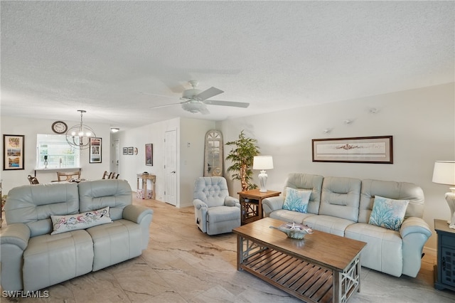 living room featuring a chandelier, ceiling fan, and a textured ceiling