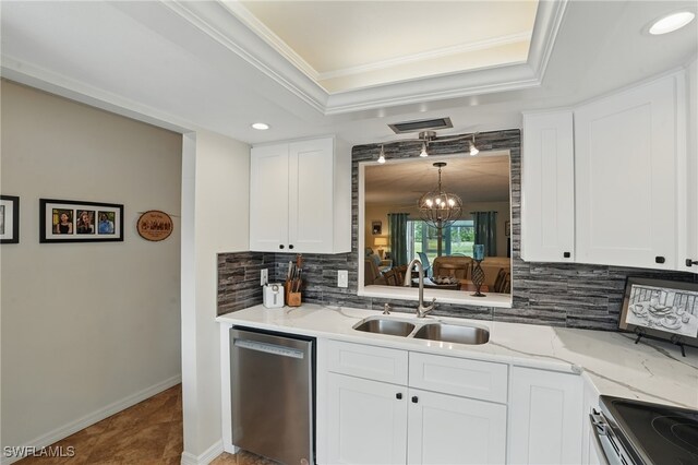 kitchen with stainless steel appliances, a sink, backsplash, a tray ceiling, and a chandelier