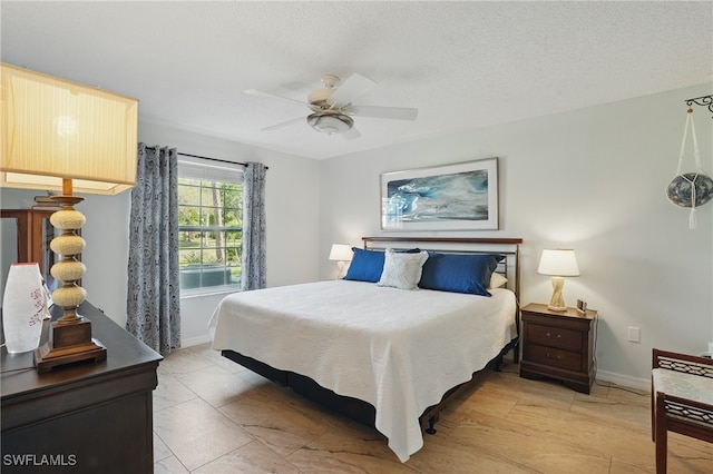 bedroom with baseboards and ceiling fan