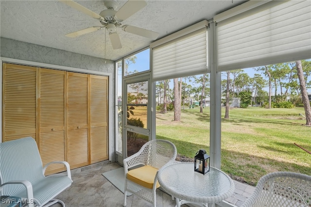 sunroom / solarium featuring ceiling fan