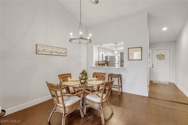 8336 Charter Club Cir Unit 10, Fort Myers, FL 33919 - dining room with dark wood finished floors, a chandelier, baseboards, lofted ceiling, and recessed lighting