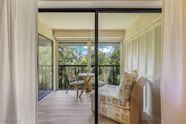 8336 Charter Club Cir Unit 10, Fort Myers, FL 33919 - sunroom / solarium featuring a textured ceiling and wood finished floors