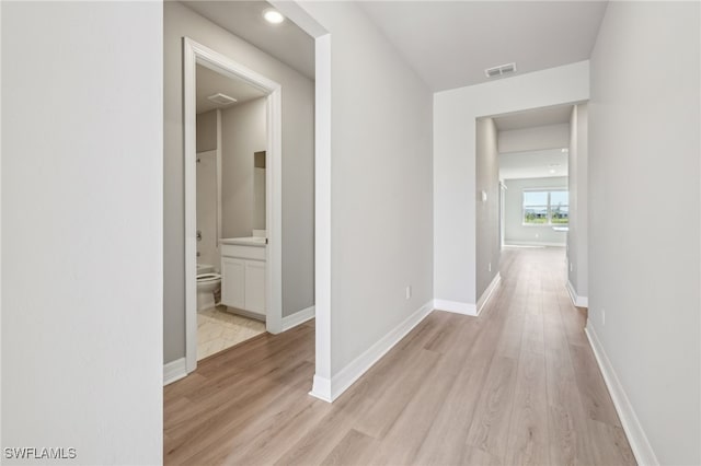 16678 Expedition Ct, Punta Gorda, FL 33982 - hall featuring light wood finished floors and baseboards