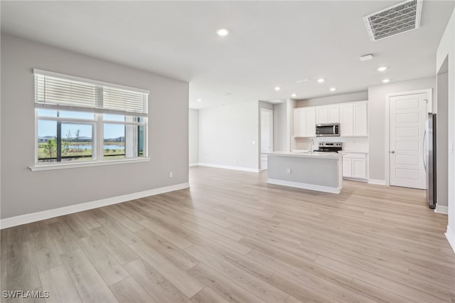 16678 Expedition Ct, Punta Gorda, FL 33982 - unfurnished living room with a sink, light wood-style flooring, recessed lighting, and baseboards