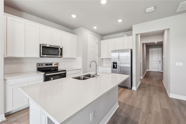 16678 Expedition Ct, Punta Gorda, FL 33982 - kitchen with stainless steel appliances, a sink, baseboards, tasteful backsplash, and light wood-type flooring