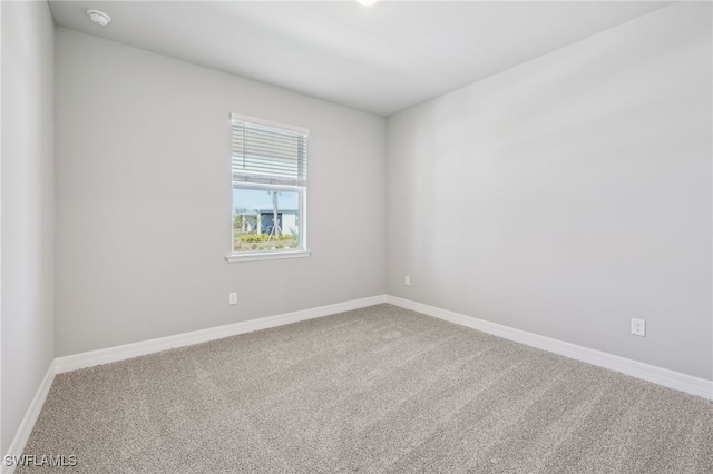 16678 Expedition Ct, Punta Gorda, FL 33982 - spare room featuring carpet flooring, a smoke detector, and baseboards
