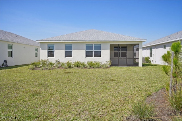 16678 Expedition Ct, Punta Gorda, FL 33982 - rear view of house featuring a sunroom, a lawn, and stucco siding
