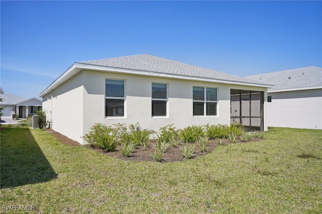 16678 Expedition Ct, Punta Gorda, FL 33982 - rear view of property with a yard, stucco siding, and roof with shingles