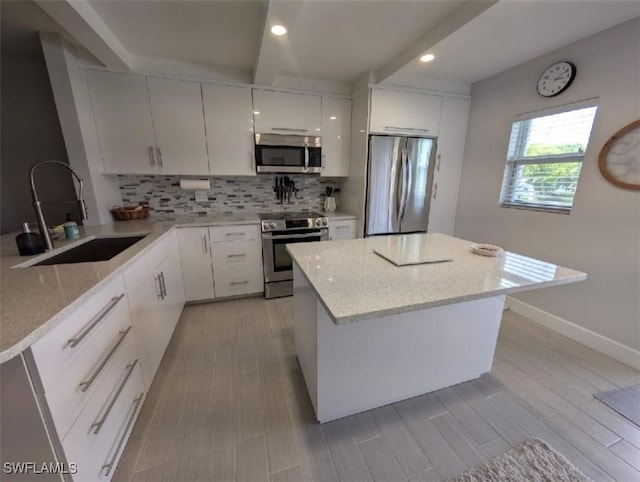 2111 Barkeley Ln Unit 13, Fort Myers, FL 33907 - kitchen with appliances with stainless steel finishes, a sink, backsplash, white cabinets, and recessed lighting