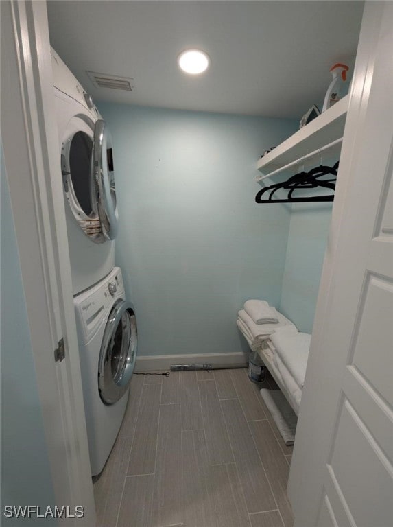 2111 Barkeley Ln Unit 13, Fort Myers, FL 33907 - laundry area featuring stacked washer / drying machine and baseboards