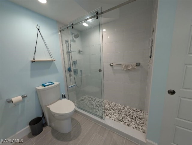 2111 Barkeley Ln Unit 13, Fort Myers, FL 33907 - bathroom featuring toilet, a shower stall, and baseboards
