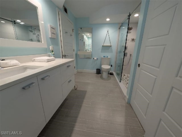 2111 Barkeley Ln Unit 13, Fort Myers, FL 33907 - bathroom with a shower stall, vanity, toilet, baseboards, and recessed lighting