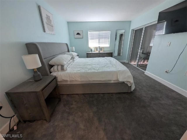 2111 Barkeley Ln Unit 13, Fort Myers, FL 33907 - bedroom with baseboards and dark carpet