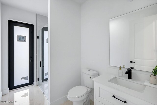 2721 NW 10th Ter, Cape Coral, FL 33993 - bathroom featuring toilet, a shower stall, baseboards, and vanity