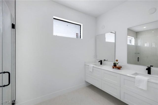 2721 NW 10th Ter, Cape Coral, FL 33993 - bathroom with a shower stall, double vanity, and baseboards