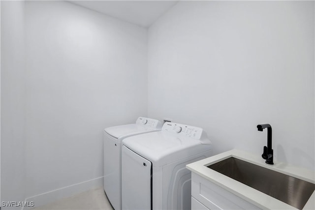 2721 NW 10th Ter, Cape Coral, FL 33993 - washroom featuring washing machine and dryer, cabinet space, and baseboards
