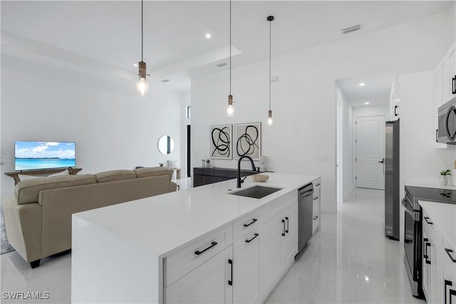 2721 NW 10th Ter, Cape Coral, FL 33993 - kitchen featuring appliances with stainless steel finishes, a sink, recessed lighting, white cabinetry, and hanging light fixtures