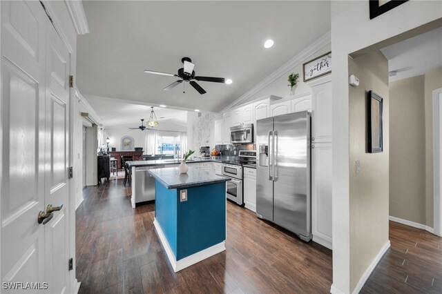 1811 NE 5th Ter, Cape Coral, FL 33909 - kitchen with stainless steel appliances, ceiling fan, vaulted ceiling, dark countertops, and white cabinetry