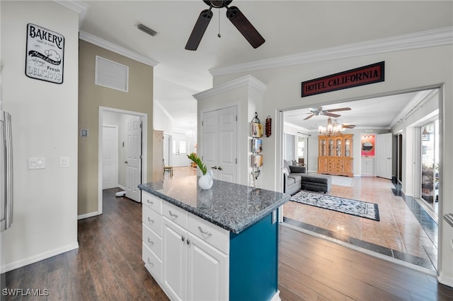 1811 NE 5th Ter, Cape Coral, FL 33909 - kitchen with ceiling fan, crown molding, healthy amount of natural light, a center island, and white cabinets
