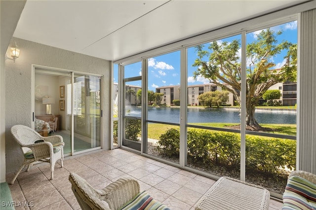 9900 Sunset Cove Ln Unit 111, Fort Myers, FL 33919 - sunroom / solarium with a water view and plenty of natural light