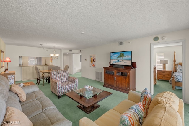 9900 Sunset Cove Ln Unit 111, Fort Myers, FL 33919 - living room with carpet floors, a textured ceiling, and a chandelier