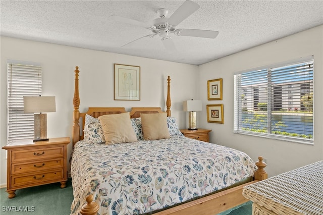 9900 Sunset Cove Ln Unit 111, Fort Myers, FL 33919 - carpeted bedroom with a textured ceiling and a ceiling fan